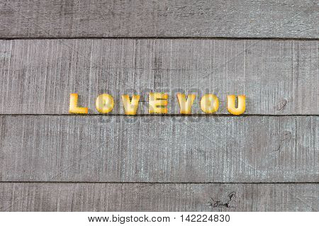 love you alphabet biscuit on wooden table stock photo