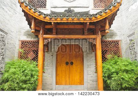 A covered wooden doorway into the xiong xiling's residence in the Fenghuang Town in Hunan Province China.