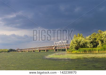 Bridge across river Dnieper in Kremenchug and storm clouds in sky