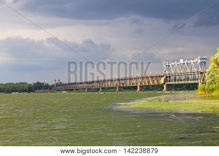 Bridge across river Dnieper in Kremenchug and storm clouds in sky