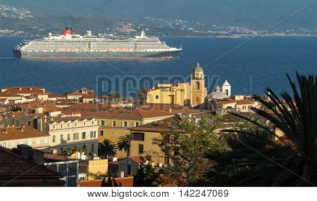 The houses of Ajaccio city the capital of South Corsica island and giant cruise ship in the background.