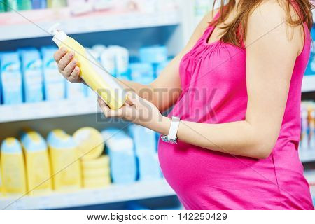 pregnant woman shopping at cosmetic shop