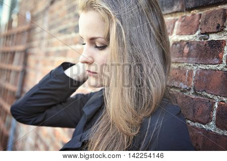 A Pretty Girl alone near grunge wall