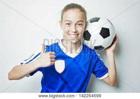 A girl in sport wear with football isolated on white background