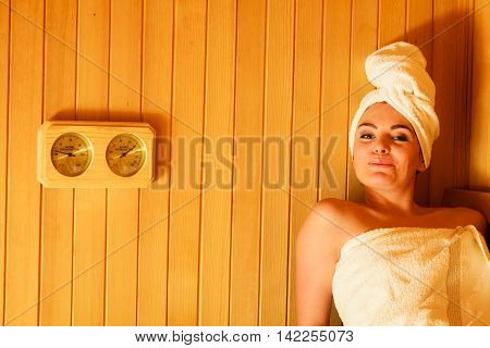 Woman Relaxing In Wooden Sauna Room