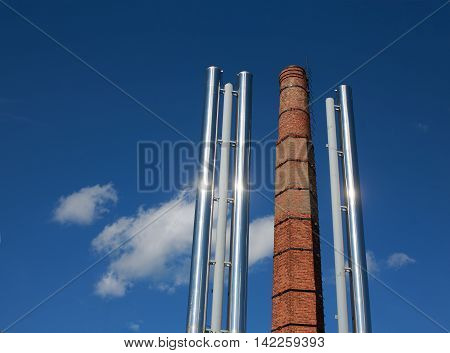 replacement of coal heating to gas. old brick chimney coal-fired boiler and two new metallic pipe gas boiler house on background blue sky.  the concept of progress in the energy industry