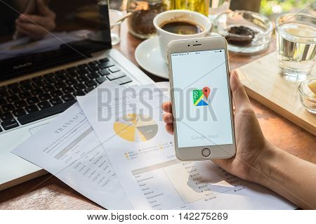 CHIANG MAITHAILAND - MAY 09: Woman hand holding IPHONE 6 PLUS with Google Maps application o. Google Maps is a service that provides information about geographical regions and sites around the world.