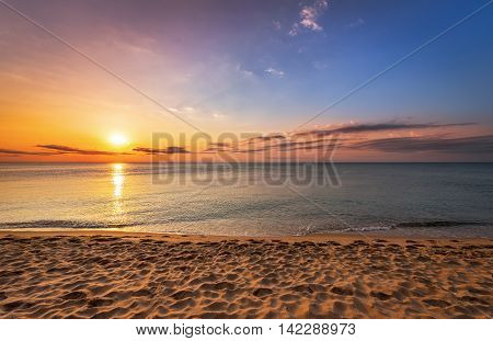 Beatiful sunrise on the tropical beach. Golden sands.
