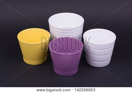 Empty flowerpots on dark background, studio shot