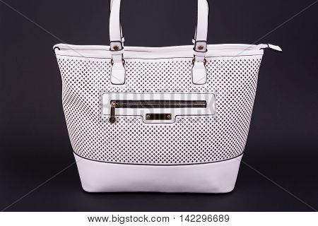 Elegant white woman handbag on dark background