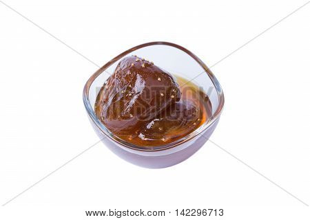 Homemade fig jam in a glass bowl isolated on white background