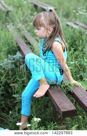 Little Girl With Long Hair Playing On Grass In Summer