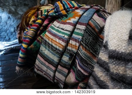 Multicolored blankets of wool drying after felting in a mountain river. Production of lizhnyk- a traditional craft in Carpathian villages. Traditional technology - weaving from hand spinning fleece