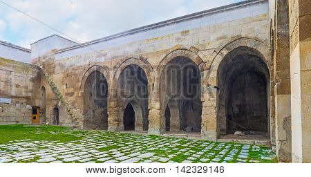 AGZIKARAHAN TURKEY - JANUARY 19 2015: The courtyard of the medieval Agzikarahan Caravan Saray with huge stone walls and warehouses for the storage of goods on January 19 in Agzikarahan.