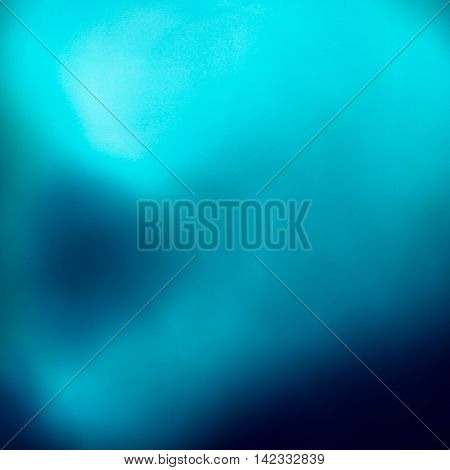 Abstract pale and dark misty blue background in square format.