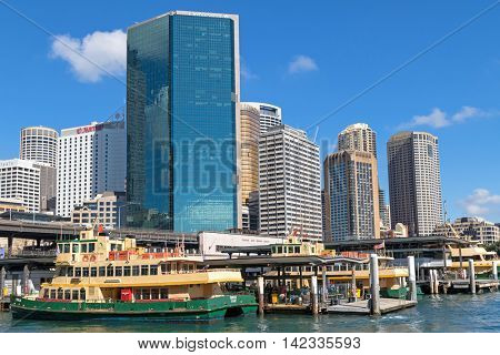 SYDNEY, AUSTRALIA - APRIL, 2016 : Sirius ferry docking in front of Circular Quay Railway station surrounded by tall hotel buildings in Sydney, Australia on April 20, 2016. 