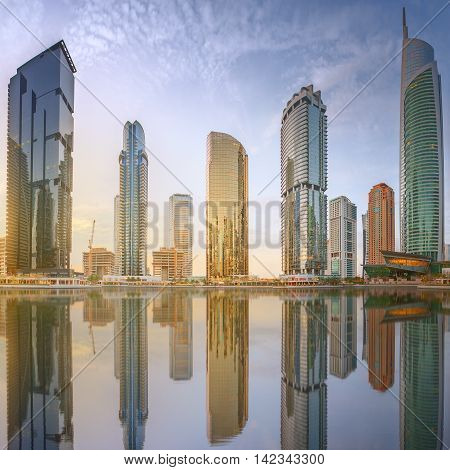 Panoramic view of Business bay and Lake Tower, reflection in a river, Dubai UAE.