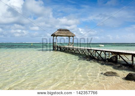 Landscape witn wooden pier in Bel Ombre beach, Mauritius island