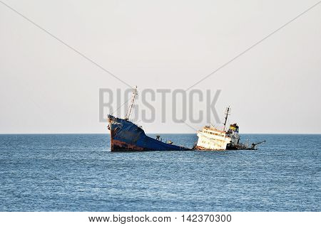 Industrial shipwreck abandoned into sea near the coastline