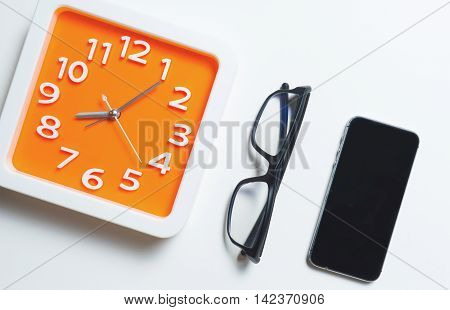 Modern Orange Clock Glasses and smart phonr