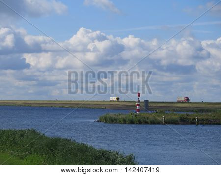 Lorries on road on dike between enkhuizen and lelystad in holland