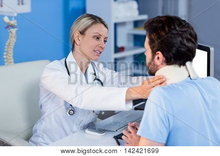 Physiotherapist examining a patients neck in the clinic