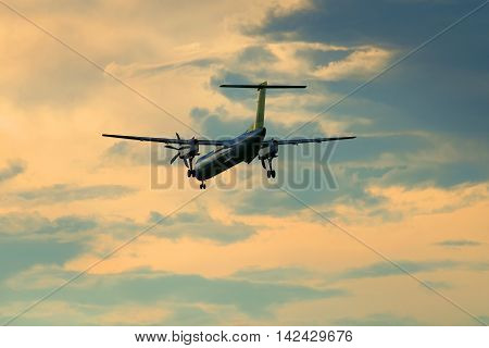 ST. PETERSBURG, RUSSIA - JULY 03, 2016: Bombardier Dash 8-Q402 (YL-BAI) airlines Air Baltic flies in the twilight sky