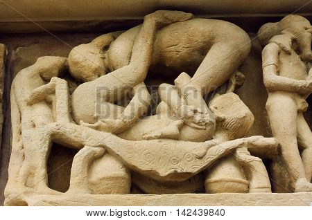 Couple in love having sex on stone relief of famous Khajuraho temple India. UNESCO Heritage site built between 950 and 1150 in India belong to Hinduism and Jainism.