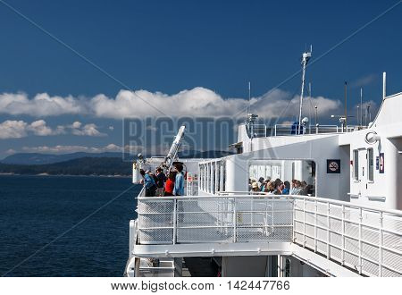 TSAWWASSEN DELTA BRITISH COLUMBIA - AUGUST 04 2016: Passengers on the sun deck of the BC Ferry. BC Ferries provides an essential link from mainland British Columbia to the various islands.