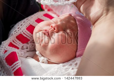 newborn baby sleeping on father's hands. Outdoor