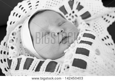 Newborn baby sleeping on a changing table.Black and white photography