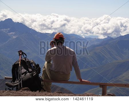 Man talking on the phone in the mountains
