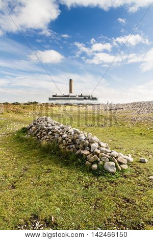 Pile Of Stones, Power Station In Distance