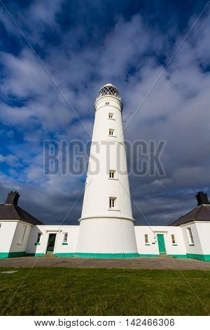 White lighthouse and associated buildings. Nash Point Vale of Glamorgan Wales.
