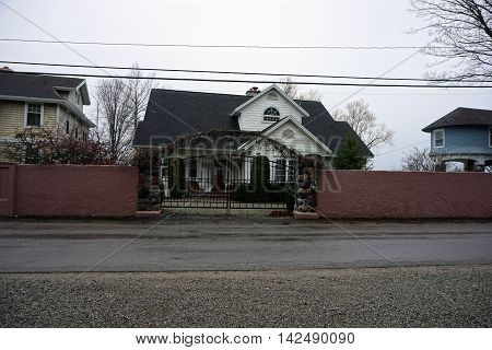 WEQUETONSING, MICHIGAN / UNITED STATES - DECEMBER 22, 2015: A tall concrete wall and a metal gate protect a home on Beach Drive in Wequetonsing.