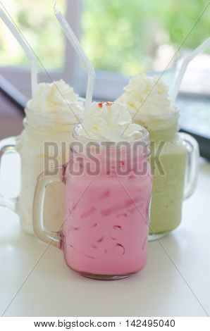 Set of different Asian soft drink Thai iced milk Thai iced green tea and Thai Iced Pink Milk on table
