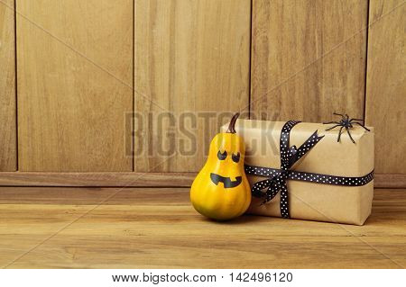 Gift box with pumpkin and spider decoration. Halloween holiday concept