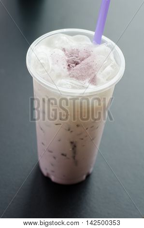 Homemade Taro Milk Bubble Tea on black table