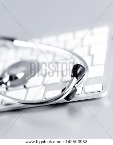 Selective focus of a computer keyboard and medical stethoscpoe. It-support.