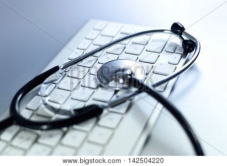 Selective focus of a computer keyboard and medical stethoscpoe. It-support.