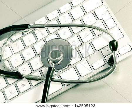 Selective focus of a computer keyboard and medical stethoscpoe. It-support.