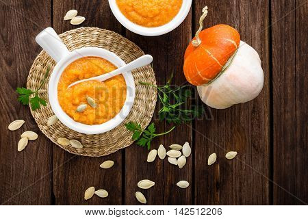 pumpkin soup on a dark wooden table