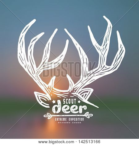 Graphic design for t-shirt with a image of deer horns. White print on blurred background