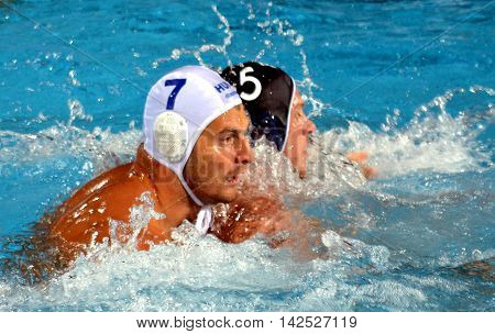 Budapest Hungary - Jul 15 2014. Adam Decker (HUN 7) defending against Romain Blary (FRA 5). The Waterpolo European Championship was held in Alfred Hajos Swimming Centre in 2014.