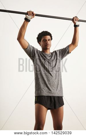 Portrait Of A Muscular Black Athlete Grabbing Carbon Pullup Bar