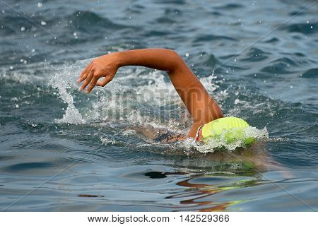Swimmer floating crawl into the blue sea.