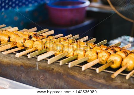 Grill fish ball with curry paste on toaster