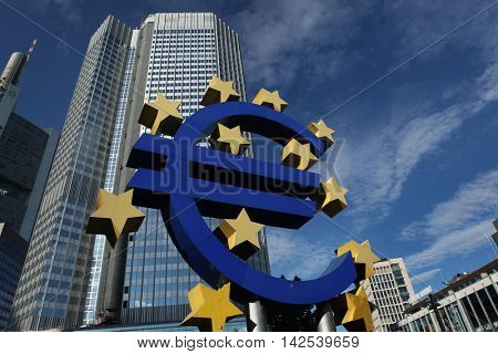 FRANKFURT AM MAIN, GERMANY - JUNE 14, 2015: Euro logo by German visual artist Ottmar HÃ?ÃÂ¶rl in front of the Eurotower in Frankfurt am Main, Hesse, Germany. 