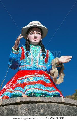 CHIVAY PERU-JANUARY 15: Statue of a local woman spinning wool on January 15 2015 in Chivay Peru. Chivay is the capital of the Caylloma province.