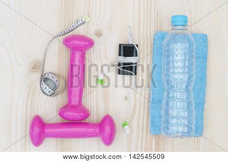 things on the table sports and pink dumbbell